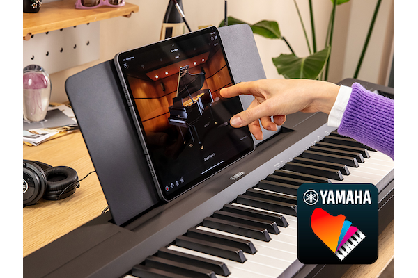 The Yamaha “Smart Pianist” app icon, together with a tablet placed on the music stand of the P-145BT